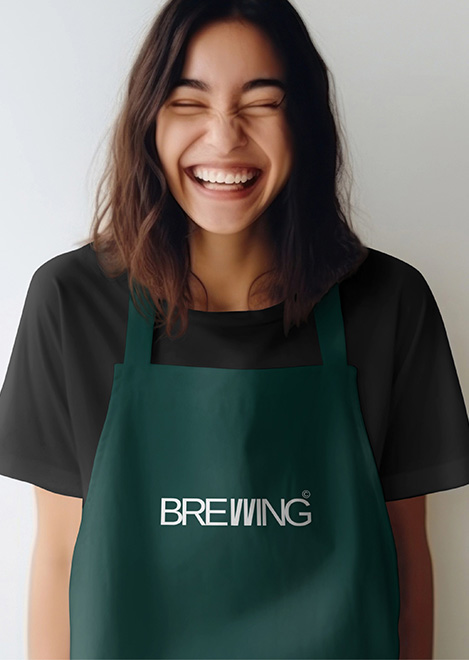 A Girl wearing a green apron with the brand logo