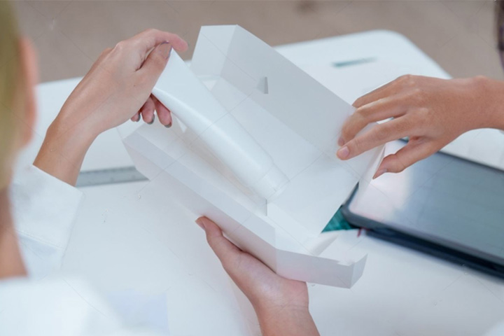 https://www.clarkemurphyprint.com.au/wp-content/uploads/2024/10/Reviewing-a-package-with-client.jpg