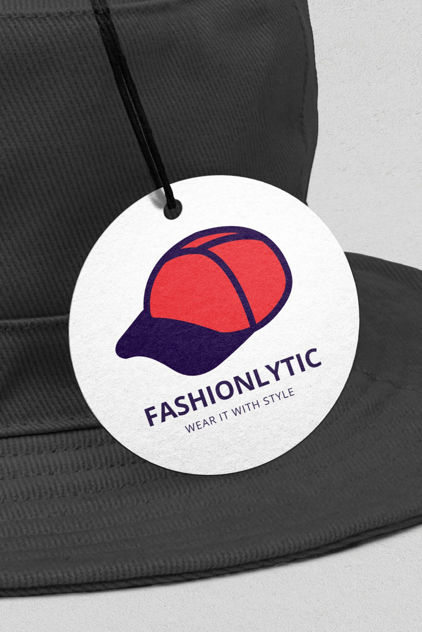 Circle String Tag attached to a cap. Matt finish.