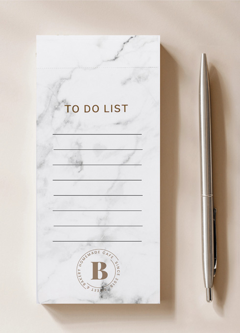 DL size branded notepads with a pen on the side