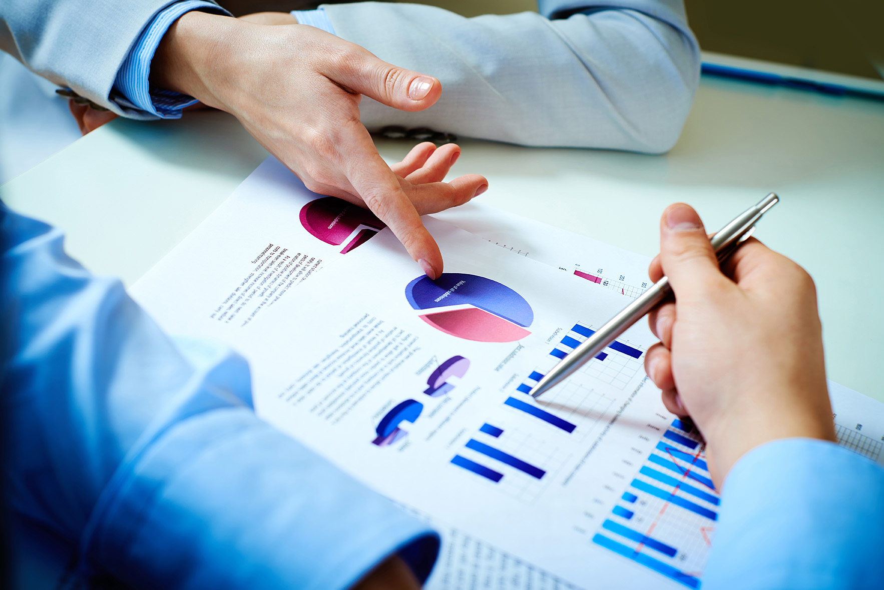 Two business people pointing out the annual report material